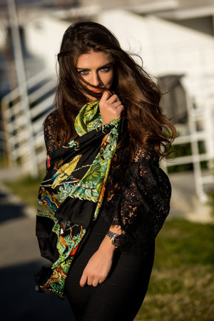 beautiful brunette girl in dress posing outdoors. Stylish model with long hairの写真素材