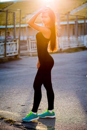 Beautiful fashion brunette girl with a sports figureの写真素材