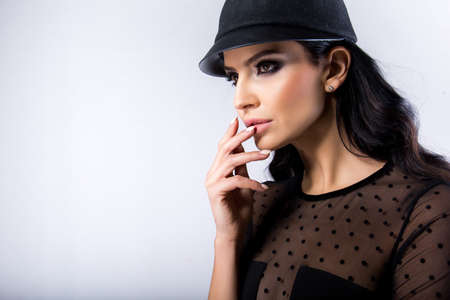 Portrait of beautiful young sexy woman with makeup and a hatの写真素材