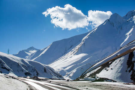 Beautiful blue skies with clouds over the mountains in the snow. Winter landscapeの写真素材