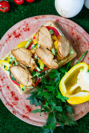 Belgian waffle with grilled meat (barbecue), and fresh vegetablesの写真素材