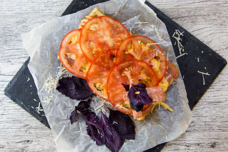 Belgian waffle with salami, cheese, tomatoes and Basilの写真素材