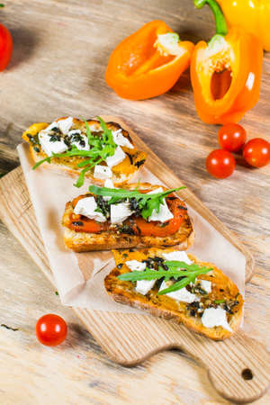 Beautiful fresh sandwiches with cheese, tomatoes and arugulaの写真素材