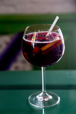Beautiful festive cocktail with strawberries and ice in the glassの写真素材
