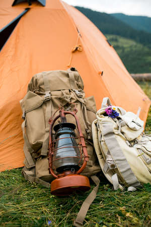 Orange touristic tent and backpacks in the nature in the mountainsの写真素材