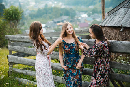 Girls girlfriend dresses rest on the nature in a beautiful mountain meadowの写真素材