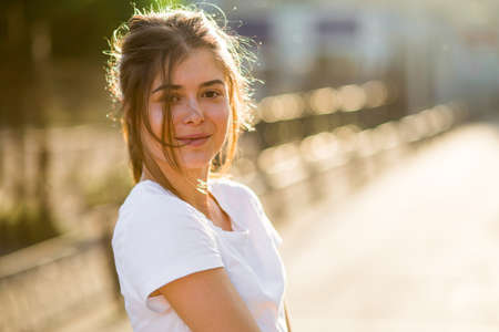 Beautiful young brunette girl doing sport outdoors in summerの写真素材
