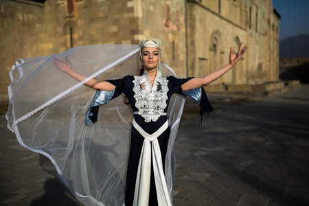 beautiful young Georgian girl near old castleの写真素材