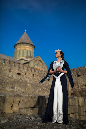 beautiful young Georgian girl near old castleの写真素材