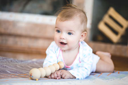Funny and cute face baby looking at camera. An adorable little girl close up.の写真素材