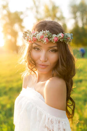 Beautiful bride in wedding dress and with a lovely mood in natureの写真素材