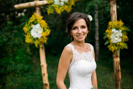 portrait of beautiful bride in wedding dress with a beautiful bouquet of flowersの写真素材