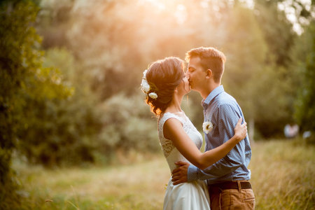 Couple on the nature, the bride and groom hugging at the wedding.の写真素材