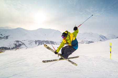 skier skiing on fresh snow on ski slope on Sunny winter day in the ski resort in Georgiaの写真素材
