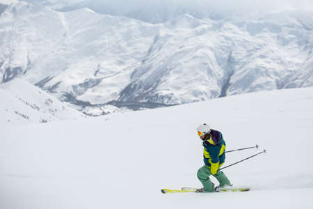 skier skiing on fresh snow on ski slope on Sunny winter day in the ski resort in Georgiaの写真素材