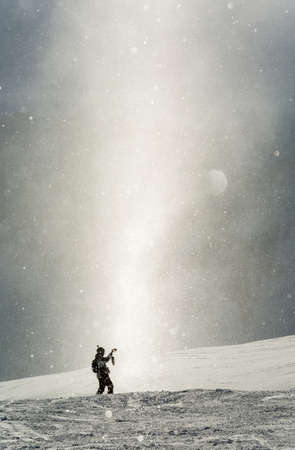 women snowboarder snowboarding on fresh white snow with ski slope on Sunny winter dayの写真素材