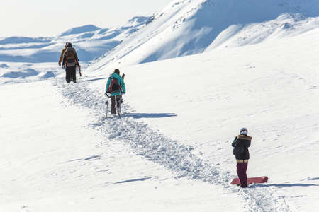 Skiers walk on the frozen trail. Beautiful winter landscape with snow-topped mountains. Ski resortの写真素材