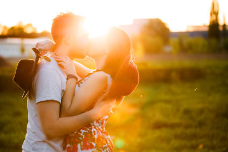 Couple in love kissing. The guy walking with his girlfriend. A man and a woman in sunglasses relaxing outdoors.の写真素材