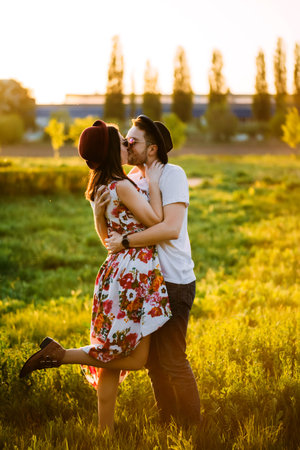 Couple in love kissing. The guy walking with his girlfriend. A man and a woman in sunglasses...