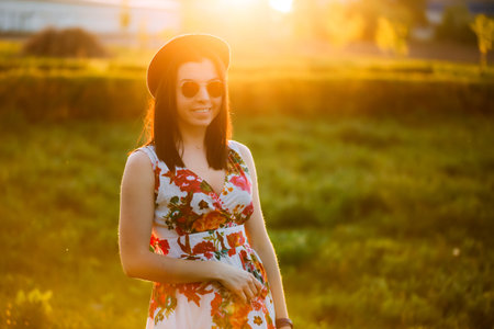 Beautiful brunette caucasian young woman laughing showing perfect teeth on summer sunny day....