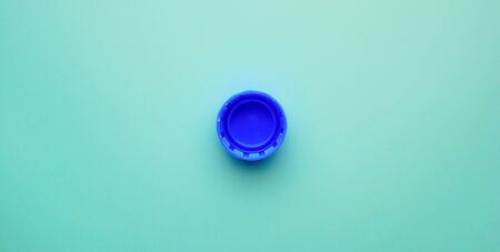 blue plastic bottle cap on blue backgroundの写真素材