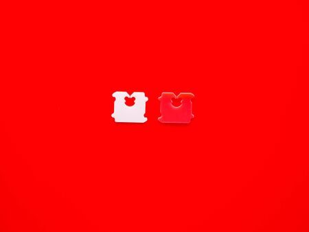 Price Tag Bread Clip and red background. The color of plastic tags on bread bag use to tell you which day of the week bread was bakedの写真素材