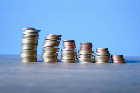 stack coins on blue background, concept business saving moneyの写真素材