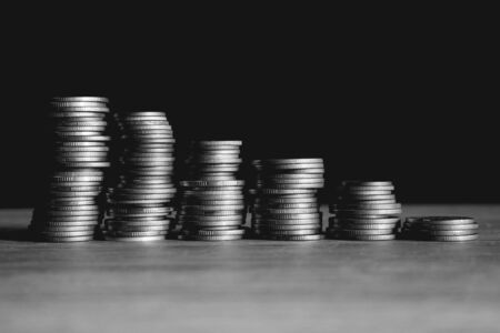 Business Finance and Money concept, Money coin stack growing graph with black backgroundの写真素材