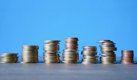 Business Finance and Money concept, Money coin stack growing graph with blue backgroundの写真素材