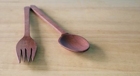 wooden spoon and fork on wood background.の写真素材