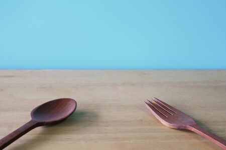 wooden spoon and fork on blue background.の写真素材