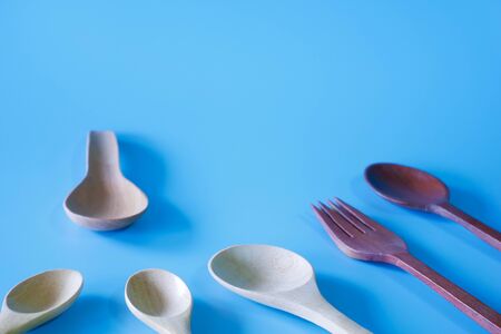 wooden spoon and fork on blue background.の写真素材