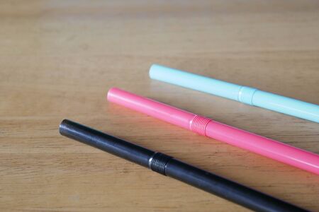 drinking straws on wood backgroundの写真素材