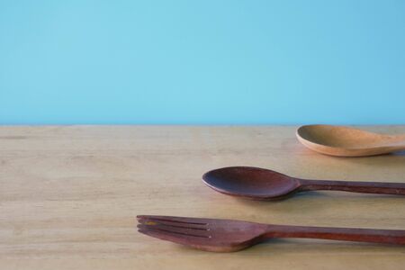 wooden spoon on blue background.の写真素材