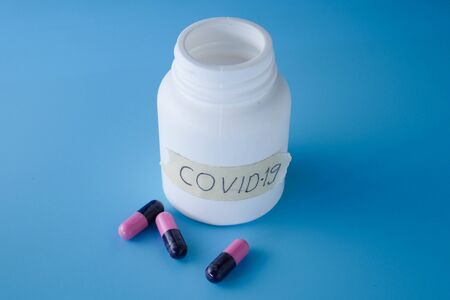 medical pills on blue background, bottle of pillsの写真素材