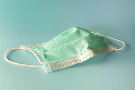 used surgical mask in clinic. discarded mask. The mask that was discarded after the virus spread.の写真素材