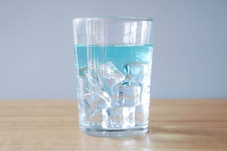 Glass of water with ice white background.の写真素材