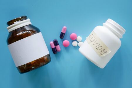 medical pills on blue background, bottle of pillsの写真素材
