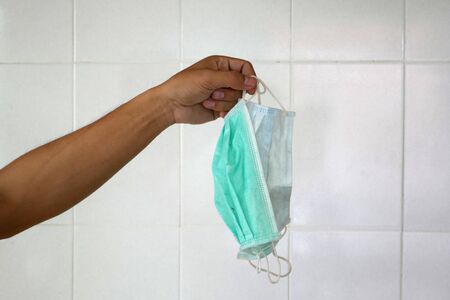 used surgical mask on the floor. discarded mask after usedの写真素材
