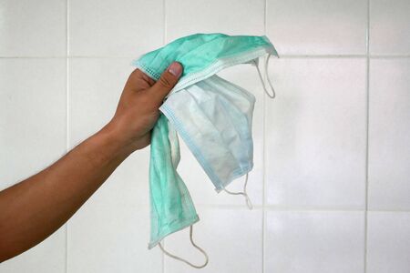 used surgical mask on the floor. discarded mask after usedの写真素材