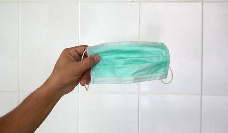 used surgical mask on the floor. discarded mask after usedの写真素材