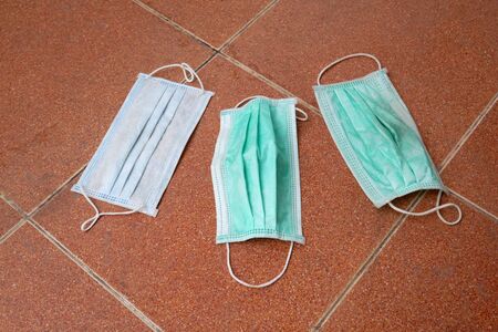 used surgical mask on the floor.の写真素材
