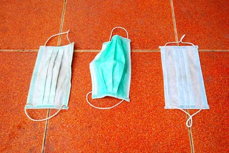 dirty surgical mask on the floor. discarded face mask.の写真素材