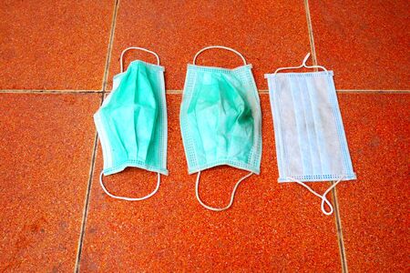 dirty surgical mask on the floor. discarded face mask.の写真素材