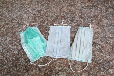 used surgical mask on the floor. discarded mask.の写真素材