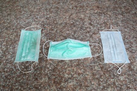used surgical mask on the floor. discarded mask.の写真素材