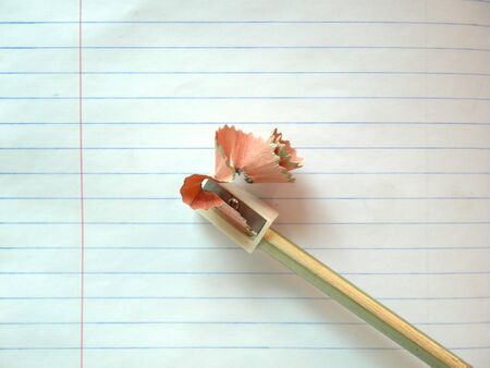 Pen and pencil sharpener on white paper backgroundの写真素材