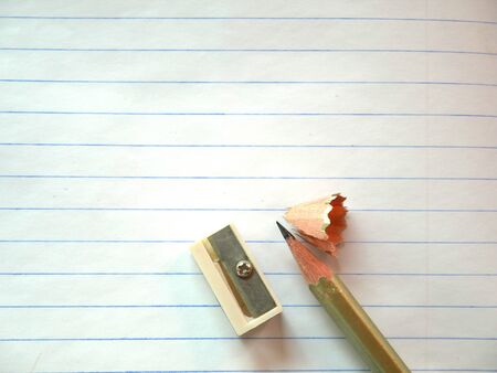 Pen and pencil sharpener on white paper backgroundの写真素材