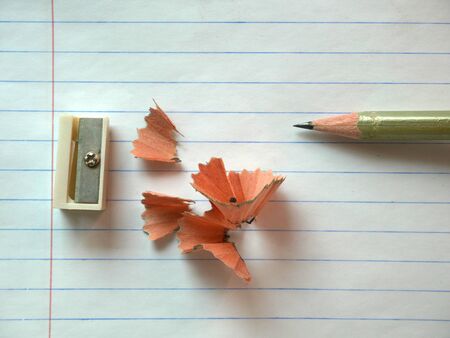 Pen and pencil sharpener on white paper backgroundの写真素材