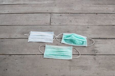 used surgical mask on the floor. discarded mask concept corona virus or covid-19.の写真素材